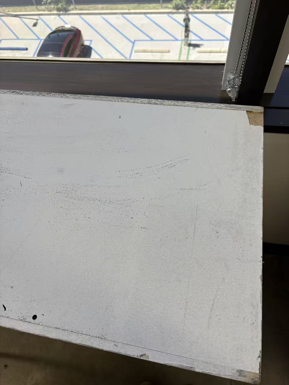 Empty white desk where the notebook had rested